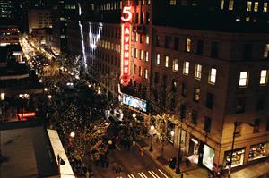 Night-time photo of Fifth Avenue in Seattle during the unveiling of  new marquee for the 5th Avenue Theatre, the street filled with crowds, on December 3, 2009