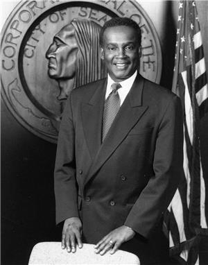 Official photo portrait taken in 1994 of Norm Rice, Seattle's first African American mayor,  with city seal in background