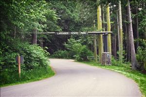 Timber sign on paved road reading "Larrabee State Park"