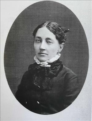 Photo of Laura Keziah Bell Coffman, oldest daughter of Seattle pioneer William N. Bell. Her dark hair is pulled back into a tight bun, held by a large hairpin, and she is wearing a dark jacket with what appears to be a black silk scarf. She also has a light-colored band around her neck that may be a turtle-neck sweater worn under her jacket.