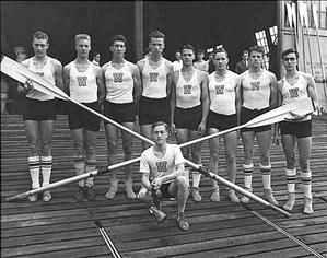 Eight oarsmen of 1936 UW Husky eight-oared crew, winners of gold at Berlin Olympic Games, pose with crossed oars, with coxswain Bob Mock kneeling in front. 