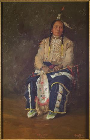 Depicts an unsmiling man, seated, facing forward but looking towards the right. Two feathers are positioned in his hair, one pointing up and the other pointing right. His two braids end in yellow ties. He is in ceremonial dress and has a pipe in his lap.