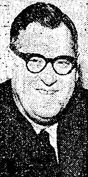 Welch posing with thick framed glasses and parted hair