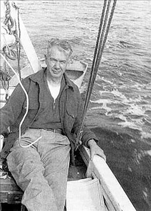 McCune reclining in a boat next to rope on the open sea