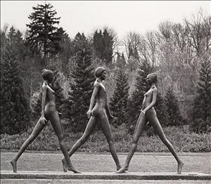 Statue of three nude female figures with hair pulled up, walking with extended legs