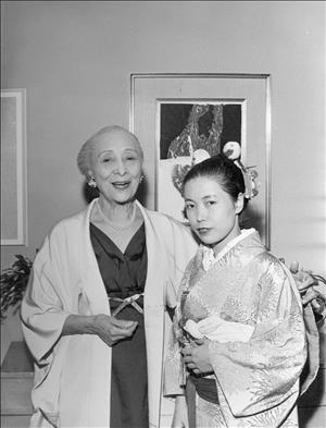 Dusanne smiling with her arm around a young woman wearing a kimono