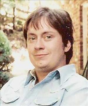 A younger McRoberts posing outside in a blue shirt
