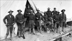 Ten Black men in military uniform standing in front of a tent