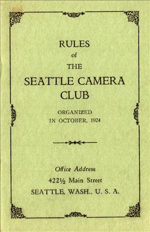 Off green cover of a book reading "Rules of the Seattle Camera Club, organized in October, 1924"