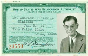 Man in tweed suit and tie on a government issued identification card reading "United State War Relocation Authority"