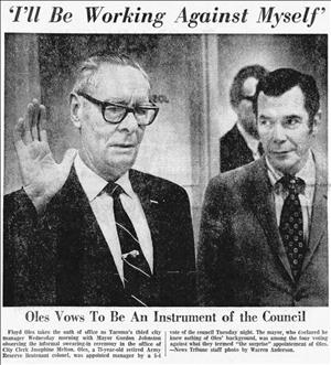 Newspaper clipping with a picture of a man in suit and tie with hand raised as a man watches him in the background with the headline "I'll be working against myself, Oles vows to be an instrument of the council"