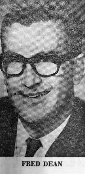 Close head shot portrait of a man in suit, tie and glasses